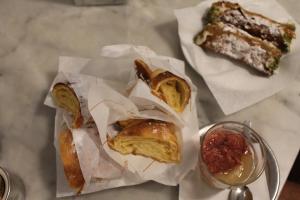 a table topped with pastries and a plate of food at Le case di Carlotta & Giorgia in Pozzillo