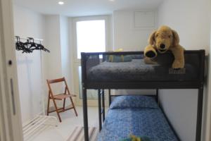a teddy bear laying on top of a bunk bed at Le case di Carlotta & Giorgia in Pozzillo