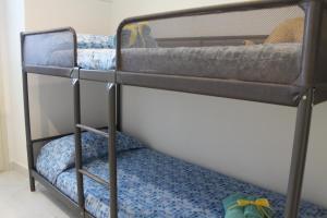 a couple of bunk beds in a room at Le case di Carlotta & Giorgia in Pozzillo