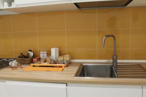 a kitchen counter with a sink and a counter top at Le case di Carlotta & Giorgia in Pozzillo +37 photos