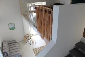 a staircase in a house with a couch and a table at Le case di Carlotta & Giorgia in Pozzillo