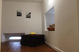 a room with a table and some pictures on the wall at Le case di Carlotta & Giorgia in Pozzillo