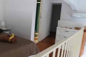 a bedroom with a bed and a staircase with a mirror at Le case di Carlotta & Giorgia in Pozzillo