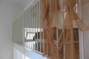 a cage with a cat sitting inside of it at Le case di Carlotta & Giorgia in Pozzillo