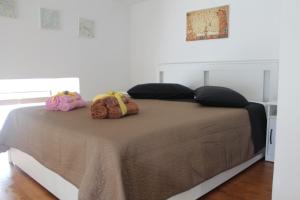 a bed with two pillows on top of it at Le case di Carlotta & Giorgia in Pozzillo
