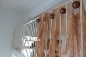 a cage with curtains on the side of it at Le case di Carlotta & Giorgia in Pozzillo