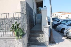 a stairway with cars parked in a parking lot at Le case di Carlotta & Giorgia in Pozzillo