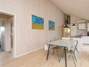a kitchen and dining room with a table and chairs at 9 person holiday home in Hj rring in Lønstrup