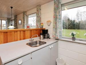 a kitchen with a sink and a window at 4 person holiday home in L s in Læsø