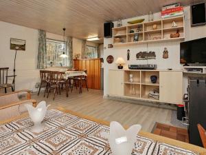 a living room with a table and a dining room at 4 person holiday home in L s in Læsø