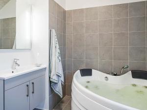 a bathroom with a white tub and a sink at 10 person holiday home in Hasselberg in Kappeln