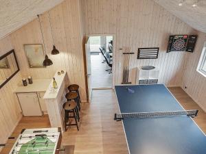 a room with a ping pong table in a room at 10 person holiday home in Hasselberg in Kappeln