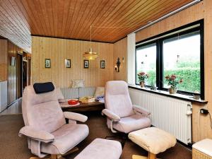 a living room with two chairs and a table at 6 person holiday home in Hemmet in Falen