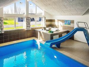 a swimming pool with a blue slide in a house at Holiday home Kappeln IV in Kappeln