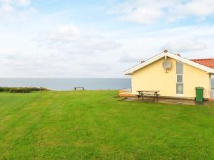 a house with a picnic table and a grass field at 4 person holiday home in Vinderup in Vinderup