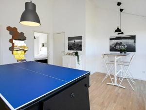a blue ping pong table in a living room at 6 person holiday home in L kken in Løkken