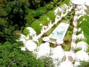 an overhead view of a garden with white domes at Igloo Beach Lodge in Manuel Antonio +85 photos