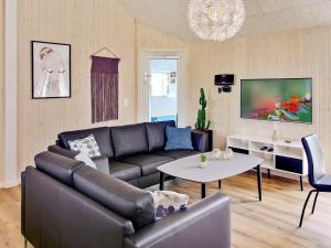 a living room with a couch and a table at 20 person holiday home in Hasselberg in Kappeln