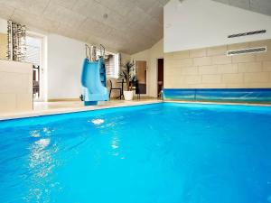an empty swimming pool with a blue pool slide at 20 person holiday home in Hasselberg in Kappeln
