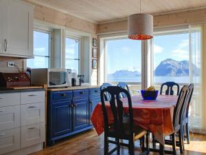 a kitchen with a table with a view of a mountain at Holiday home Dønna in DÃ¸nnes