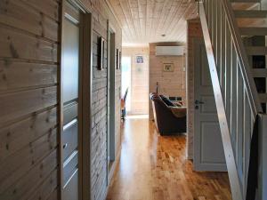 a hallway of a house with wooden walls and wood floors at 6 person holiday home in Dønna in DÃ¸nnes