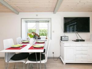 a dining room with a white table and chairs at 4 person holiday home in Asaa in Aså