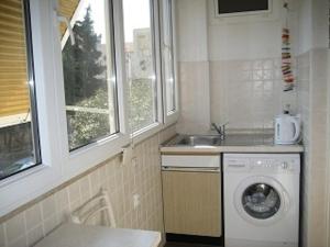 a kitchen with a washing machine and a sink at Apartments Lucac Manus in Split