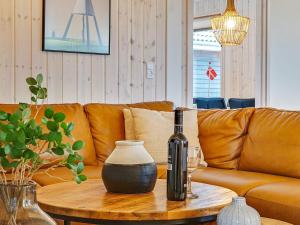 a living room with a couch and a bottle on a table at 20 person holiday home in Grenaa in Grenå