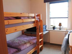 two bunk beds in a room with a window at Pleasant Apartment in Kropelin With Terrace in Kröpelin