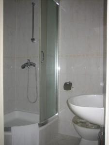 a bathroom with a shower and a toilet and a sink at Apartments Lucac Manus in Split