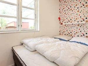 two beds in a bedroom with a window at 6 person holiday home in Store Fuglede in Store Fuglede