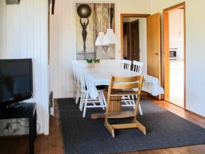 a dining room with a white table and chairs at 6 person holiday home in Str by in Strøby