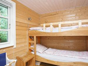 a wooden cabin with two bunk beds in it at 8 person holiday home in Fjerritslev-By Traum in Torup Strand