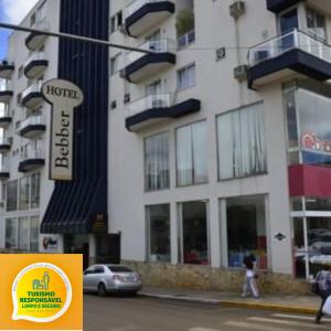 a person walking down a street in front of a building at Bebber Hotel in Campos Novos