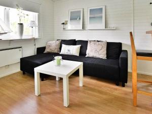 A seating area at 4 person holiday home in Gr nna