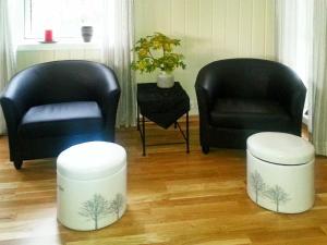 duas cadeiras e dois bancos numa sala de estar em 8 person holiday home in Tengelfjord em Tengelfjorden