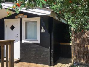 a black and white shed with a door at 5 person holiday home in Stege in Stege