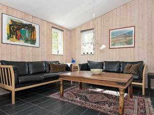 a living room with a couch and a coffee table at 10 person holiday home in Ebeltoft in Ebeltoft