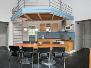 a kitchen with a large wooden table and chairs at 10 person holiday home in Ebeltoft in Ebeltoft