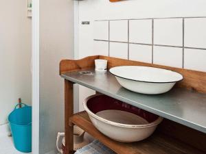 a kitchen with a counter with a bowl on a shelf at 4 person holiday home in Bryrup in Bryrup