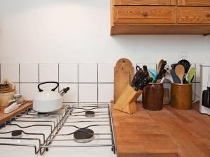 a kitchen stove with a tea kettle on top of it at 4 person holiday home in Bryrup in Bryrup