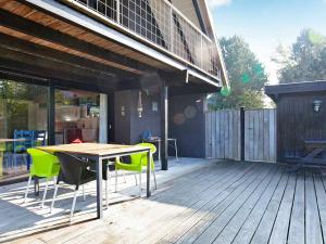 a patio with a table and chairs on a deck at 6 person holiday home in Knebel-By Traum in Skødshoved Strand