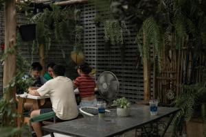 a group of people sitting at a table at Baannokhook Home&Cafe in Suratthani
