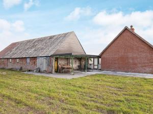 an old brick barn with a large roof at 7 person holiday home in Harbo re in Harboør