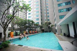 a group of people in a swimming pool in a building at KLCC One Bedroom apt & Studio in Kuala Lumpur