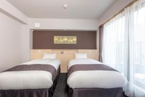 Postel nebo postele na pokoji v ubytování Hotel GOCO stay Kyoto Shijo Kawaramachi