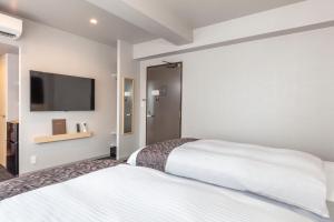 Hotel GOCO stay Kyoto Shijo Kawaramachi tesisinde bir odada yatak veya yataklar