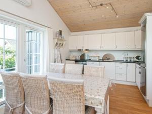 a kitchen with a table and chairs in a room at 7 person holiday home in Hemmet in Hemmet