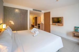 A bed or beds in a room at Grand Livio Kuta Hotel