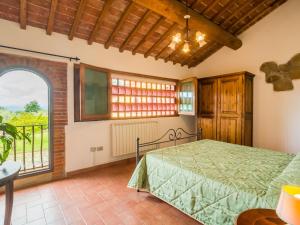 a bedroom with a bed and a large window at Scenic Apartment Near Pian di Sco with Private Terrace in Pian di Scò